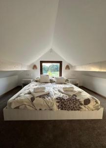 a large white bed in a room with a window at Willa Parys in Władysławowo