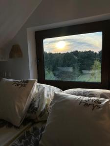 a bedroom with two beds and a large window at Willa Parys in Władysławowo