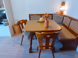 a dining room table with chairs and a wooden table at Nassfeld and Lake Apartment in Hermagor