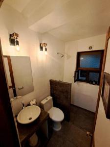 a bathroom with a white toilet and a sink at Casa Nora Malinalco: entire estate w/pool 