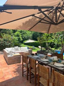 a table with chairs and an umbrella on a patio at Casa Nora Malinalco: entire estate w/pool 
