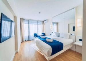 a bedroom with a large bed and a large window at Aparthotel orbi with Sea View in Batumi