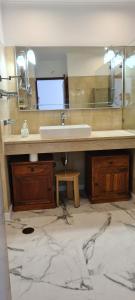 a bathroom with a sink and a large mirror at Penthouse with panoramic view in Vilamoura +14 photos