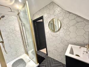 a bathroom with a shower and a sink and a mirror at Pristine Flat Within Heart Of Worthing in Worthing