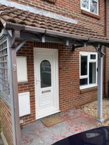 a front door of a brick house with a white door at Guest House with garden and 2x parking space in Southampton