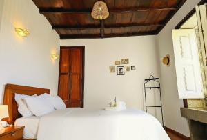 a bedroom with two beds and a wooden ceiling at Torre de Santiago - Guest House in Vila Praia de Âncora