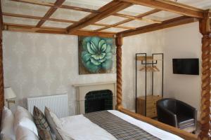 a bedroom with a bed and a fireplace at The Rectory Lacock - Boutique Bed and Breakfast in Lacock