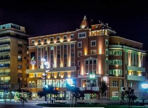 a large building at night with its lights on at Seventy in Póvoa de Varzim