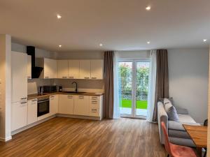 a kitchen and living room with a couch and a table at Schlüssel Apartments in Lahr