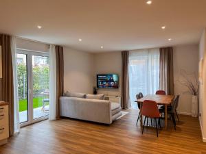 a living room with a couch and a table at Schlüssel Apartments in Lahr