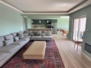 a living room with a couch and a table at Retreat Villa, 17m to Downtown, up to 29ppl in Lisbon