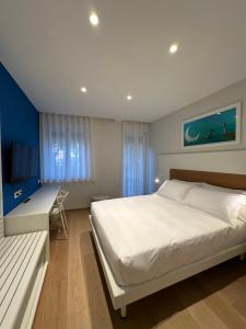a bedroom with a bed and a desk and a television at Le Ciulla Luxury B&B in Pescara