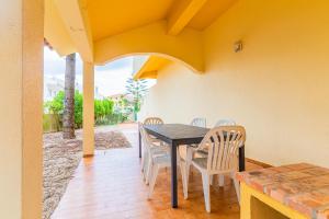 comedor con mesa y sillas en el patio en Beach House Villa At Peniche - Praia Consolação, en Atouguia da Baleia