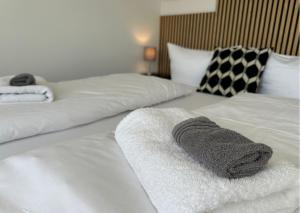 a bed with two white towels on it at Buddha Apartment in Koblenz