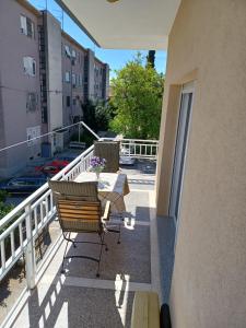 a balcony with a bench and a table on a building at Studio apartman Marija in Trogir