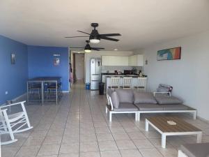 a living room with a couch and a table at Peaceful ocean front home near Rainforest & rivers in Luquillo