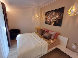 a bedroom with a white bed with pillows on it at Pärnu Posti Apartment in Pärnu