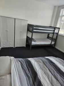 a bedroom with a bunk bed and white cabinets at 15 Espionage Place, Portland in Portland