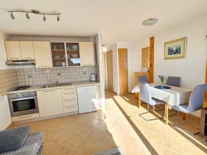 Apartment Ivana with a nice see view في كافتات: مطبخ وغرفة معيشة مع طاولة وكراسي