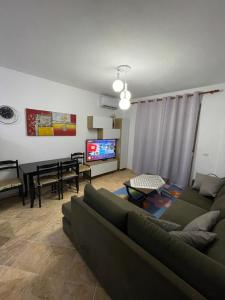 a living room with a couch and a table at Apartament 1+1 Golem in Golem