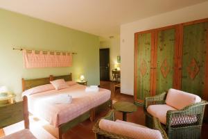 una camera con un letto e due sedie di Hotel Ristorante Sa Pedrera a Càbras