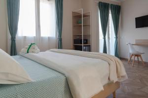 Postel nebo postele na pokoji v ubytování Gigli Rooms