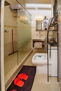 a bathroom with a shower and a toilet and a sink at PNG Guest house Kitende in Kampala