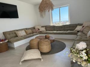 a living room with a couch and a table at Beach house La Marina in La Marina