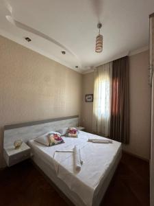 a bedroom with a large white bed with two pillows at Guesthouse Old Town in Kutaisi