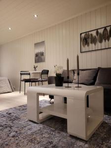 a living room with a couch and a table at Riverside apartment in Skien in Skien