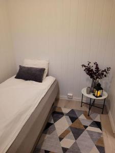 a bedroom with a bed and a table with a plant at Riverside apartment in Skien in Skien