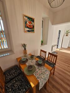 a dining room with a wooden table and chairs at Pokoje przy Parkowej in Zwierzyniec