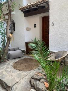 a porch of a house with a chair and a door at Casa Halcón in Jávea