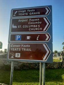 a street sign with many signs on it at Willow Cottage Accommodation in Sligo