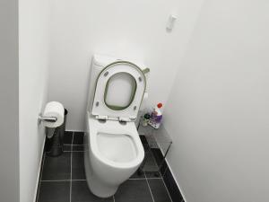 a bathroom with a toilet with the lid up at Queen Bed Guest Room in Brand New House in Leppington