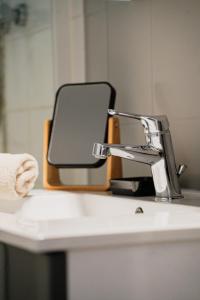 a mirror sitting on top of a bathroom sink at Moderne lumineux centre ville et plage à 5 min Proche place Strasbourg in Brest