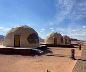 two domes in the middle of the desert at Desert Eyes Camp in Wadi Rum