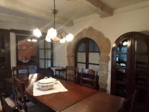 a dining room with a wooden table and chairs at Palacio de Cantiz in Becerreá