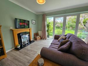 a living room with a couch and a fireplace at Luxury Self Catering in Colchester in Colchester