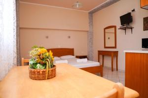 - un salon avec une table et un panier de fleurs dans l'établissement Villa Mare Ammoudia, à Ammoudia