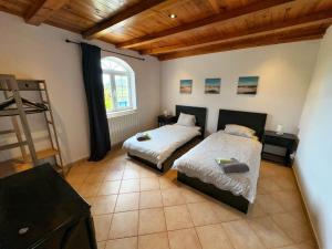 a bedroom with two beds and a wooden ceiling at Oasis Camp Portugal in Lagoa