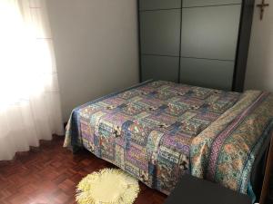 a bedroom with a bed and a rug on the floor at La mimosa in San Mauro Pascoli