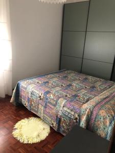 1 dormitorio con cama y alfombra en el suelo en La mimosa, en San Mauro Pascoli