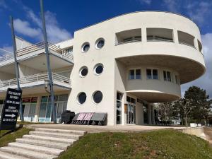 a large white building with round windows on it at Appartement port dienville in Dienville