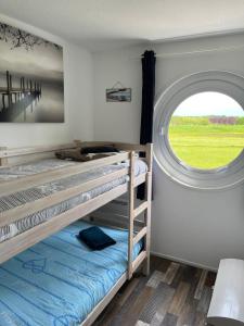 a bedroom with two bunk beds and a window at Appartement port dienville in Dienville