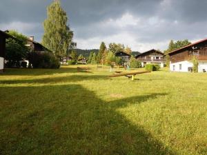 a park with several picnic tables in the grass at Holiday apartment Brandl Haus 92 in Arrach