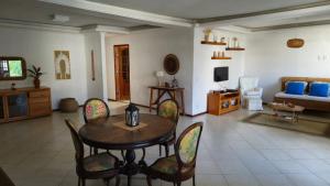 a living room with a table and chairs and a couch at Aldeia Maravista in Niterói