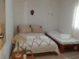 a bedroom with a bed and a table with a lamp at Aldeia Maravista in Niterói +78 photos