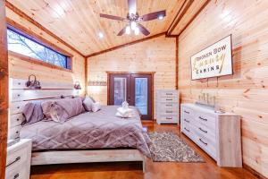 a bedroom with a bed and a ceiling fan at The Luxurious Blue Sky Lodge is EPIC! in Broken Bow