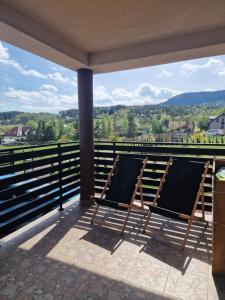 a group of chairs on a porch with a view at Dom w górach in Lipnik